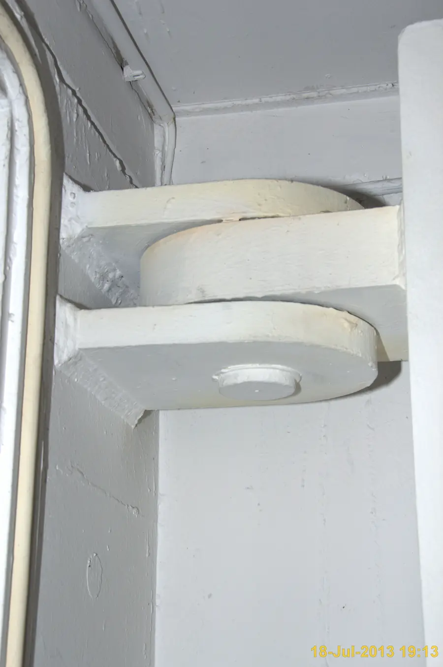 Heavy-duty door hinge on a white steel door frame