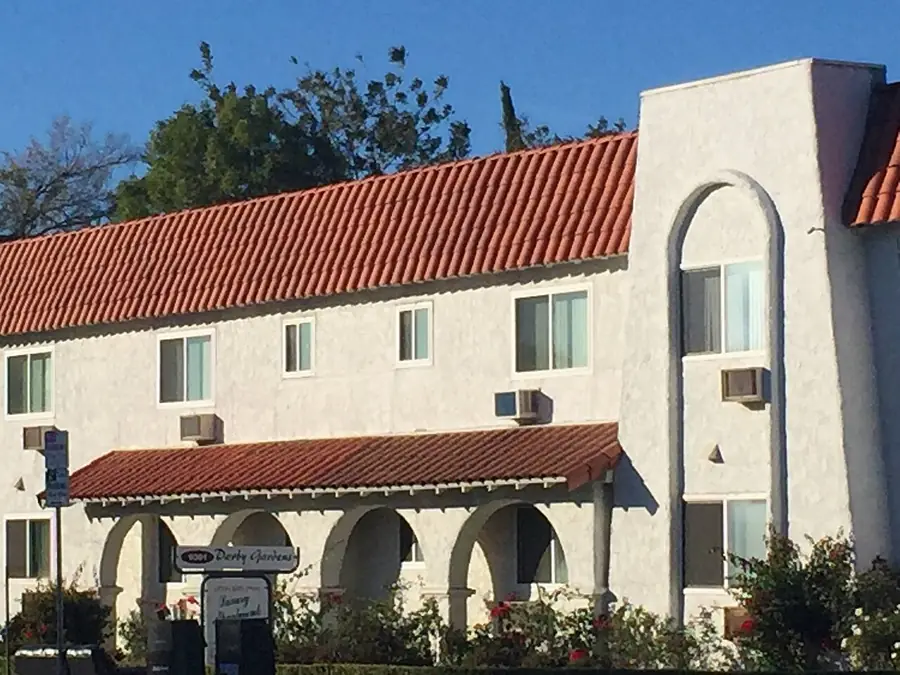 Stucco apartment building with a red tile roof in Los Angeles