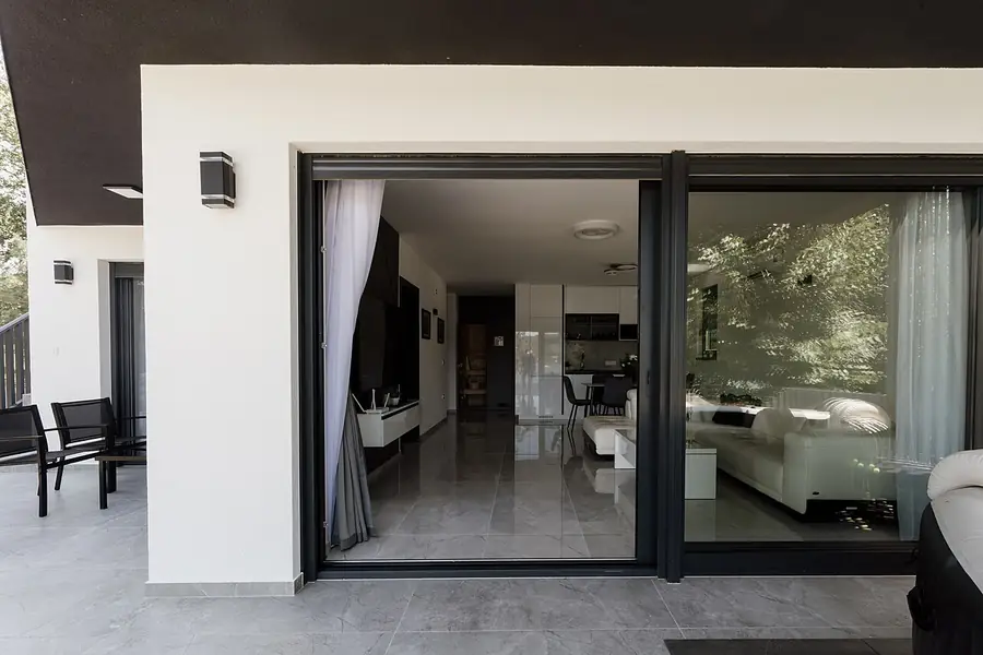 Living room opening to a patio through sliding glass doors