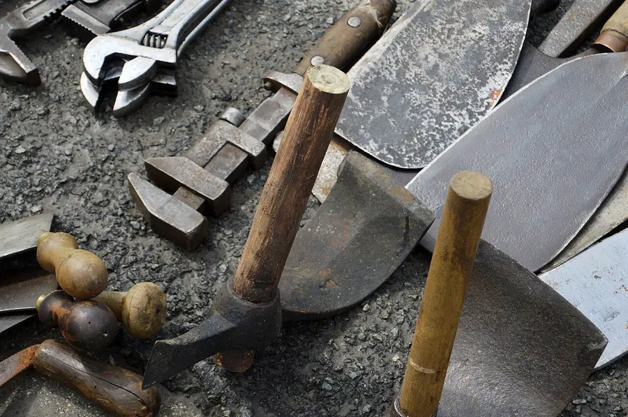 Assorted hand tools laid out together, including pliers, wrenches and screwdrivers