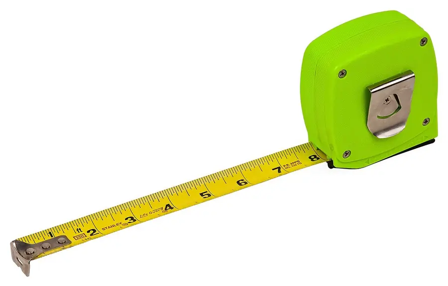 Green tape measure with its yellow blade pulled out on white