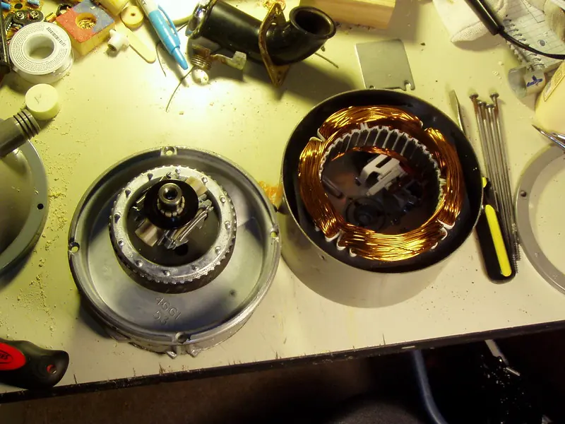 Inside a worn garbage disposal with a rusted grinding plate