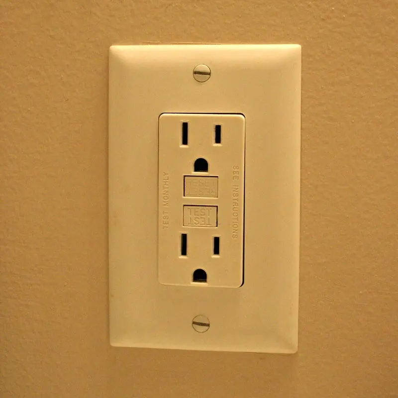 Ivory GFCI outlet with test and reset buttons in a clean cover plate