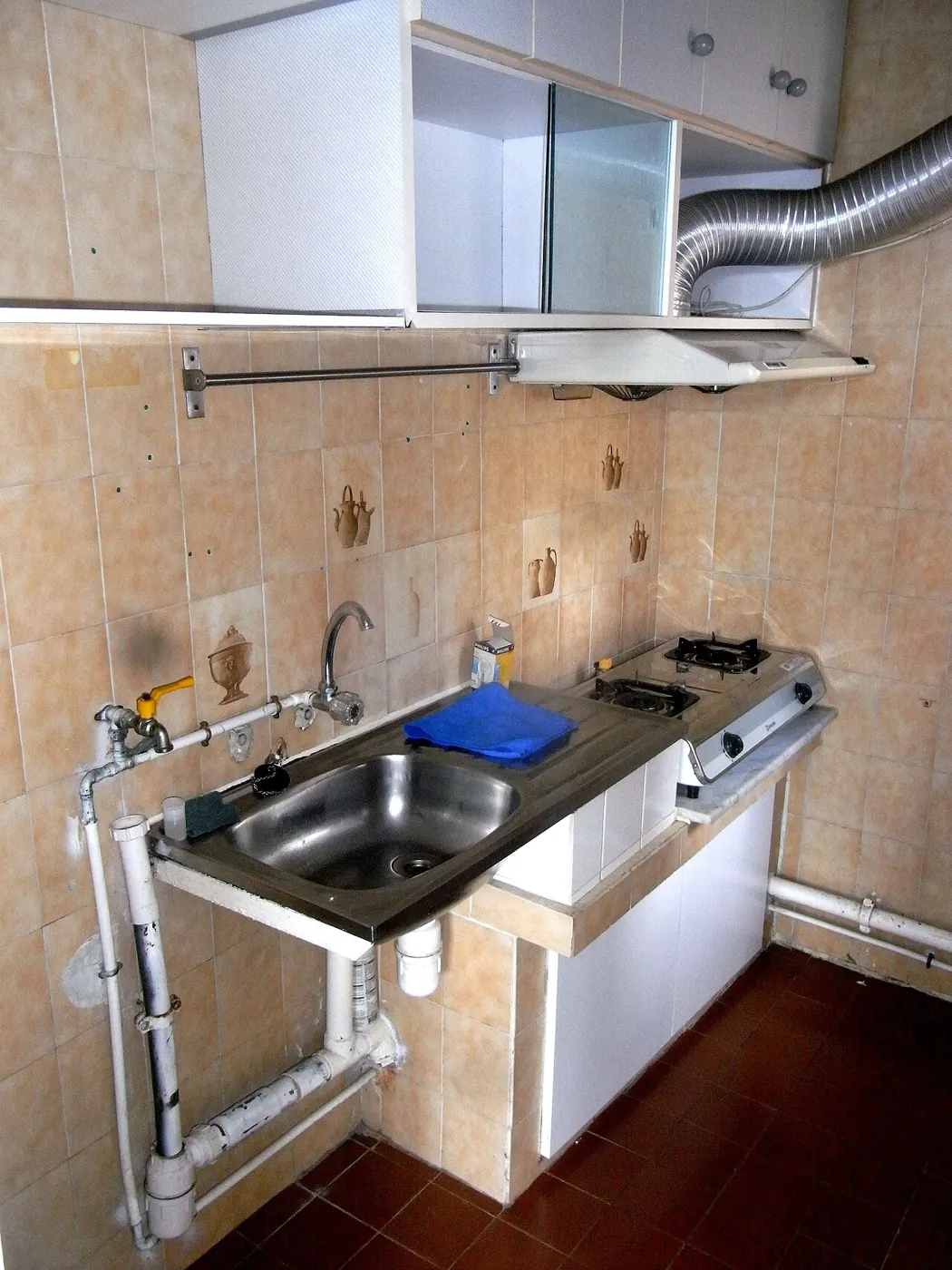 Small apartment kitchen with sink and cabinets