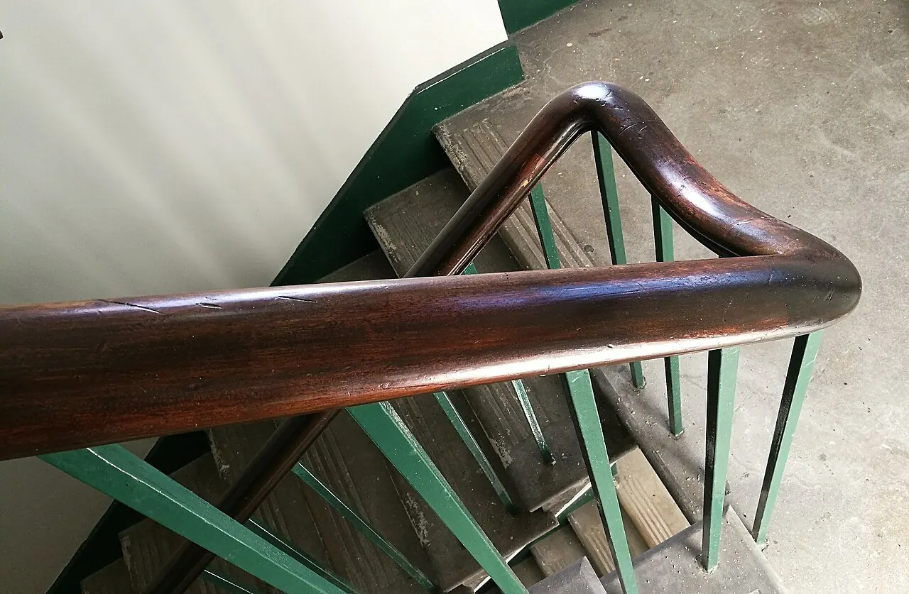 Wooden handrail running along a staircase