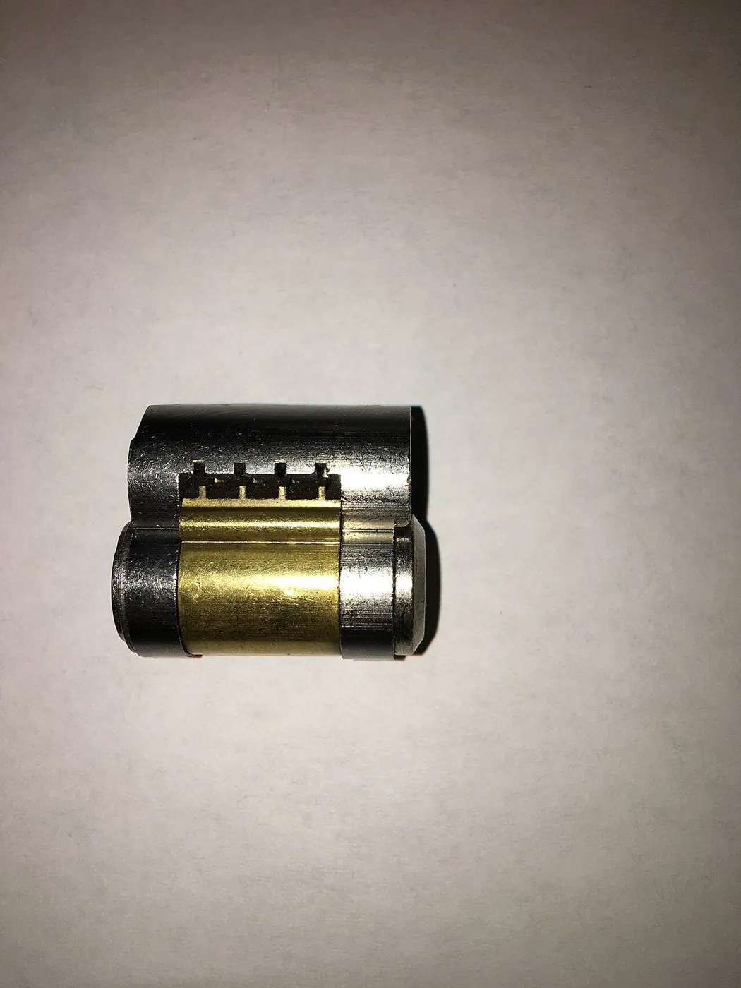 Lock core removed from its housing, showing the pin chambers