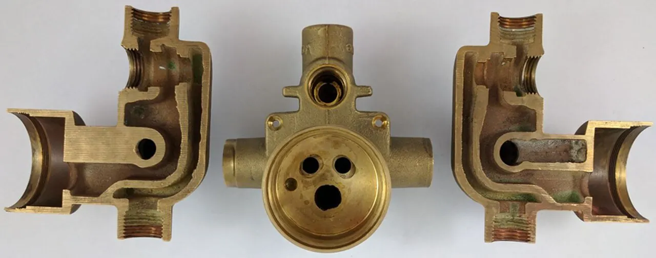 Shower mixer valve body shown whole and cut in half