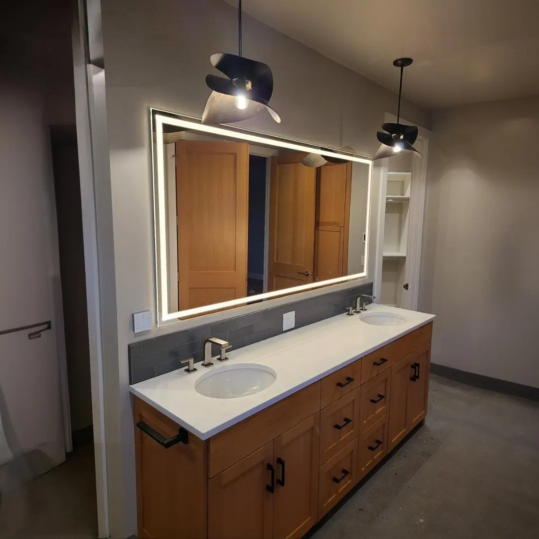 Lighted mirror installed above a bathroom vanity