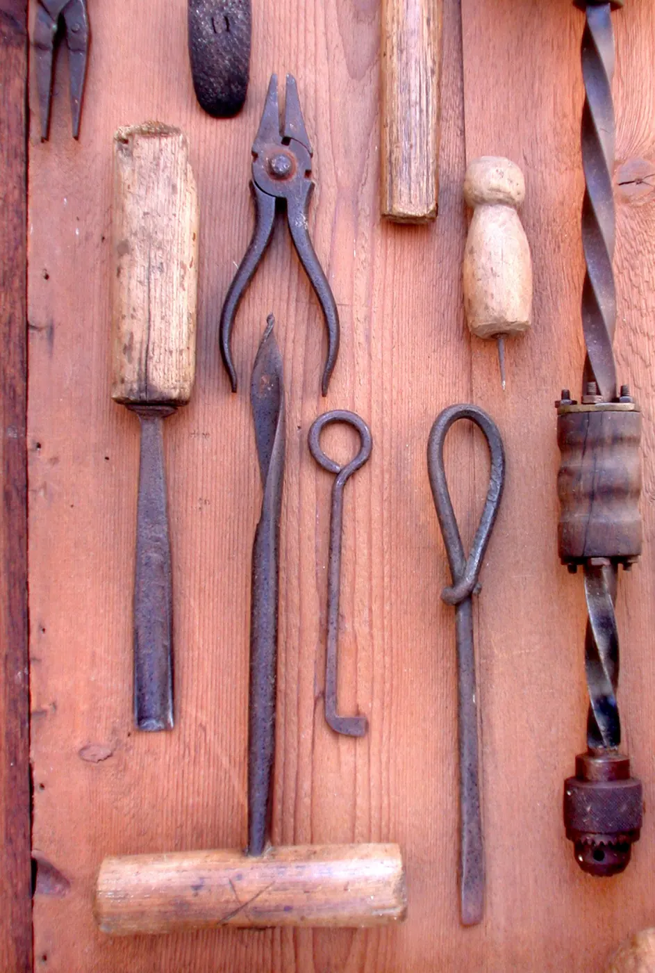 Old woodworking hand tools hung on a wall