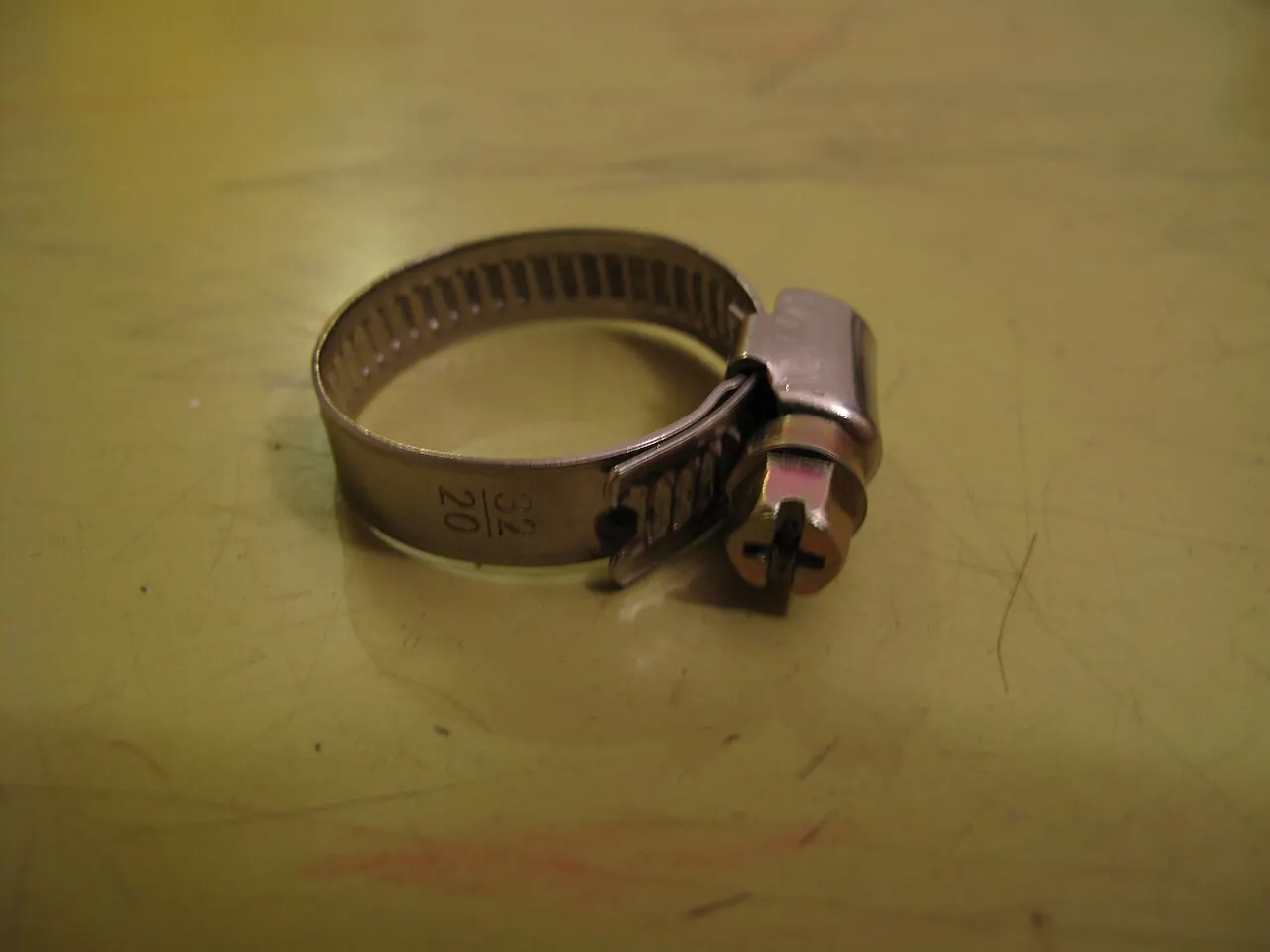 Screw-type hose clamp used to hold a hose on a fitting