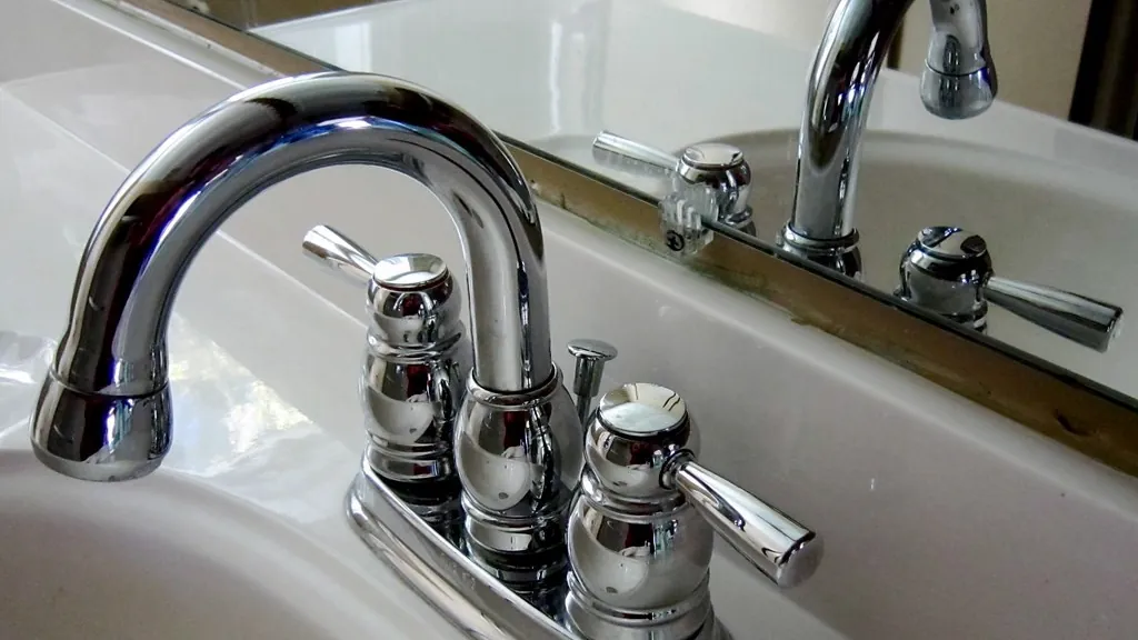 Chrome bathroom faucet on a white sink
