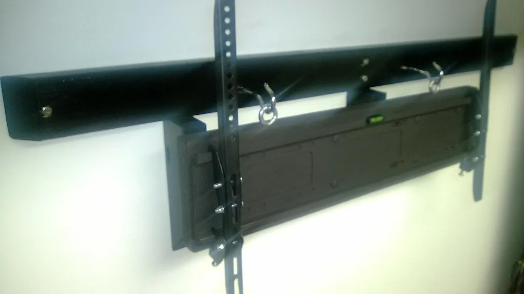Empty black TV wall mount bracket fixed to a wall