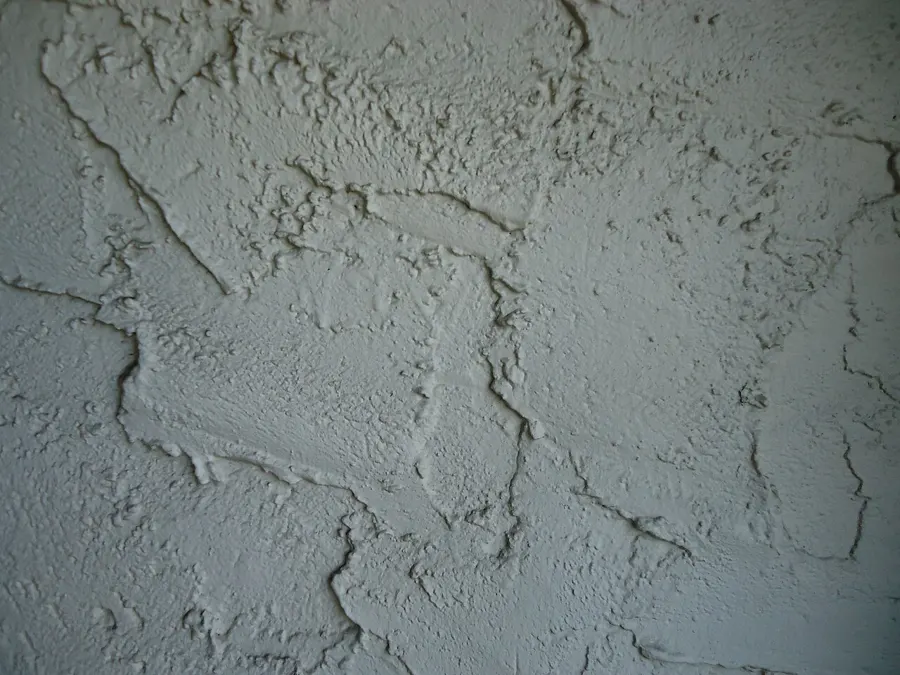 Close view of a textured stucco wall surface