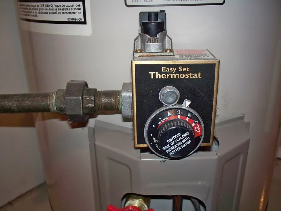 Gas control and thermostat dial on the front of a tank water heater