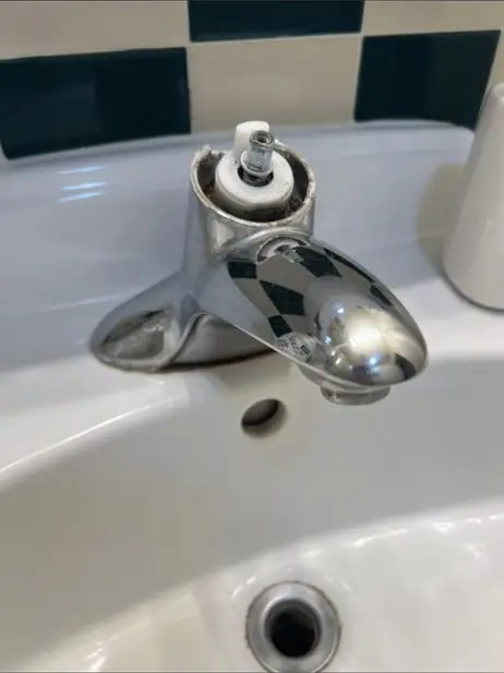 Chrome single-handle bathroom faucet on a white basin