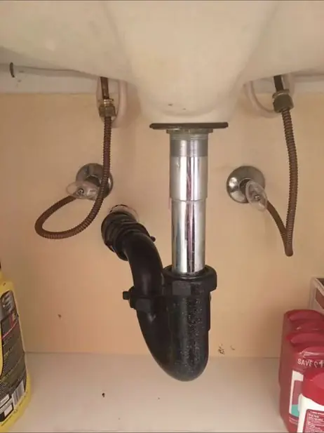 Bathroom sink drain and P-trap replaced under a vanity