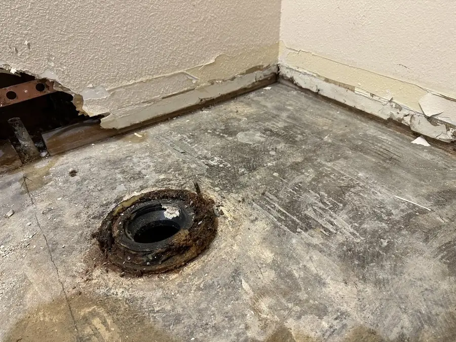 Toilet flange in a bathroom floor with the toilet removed