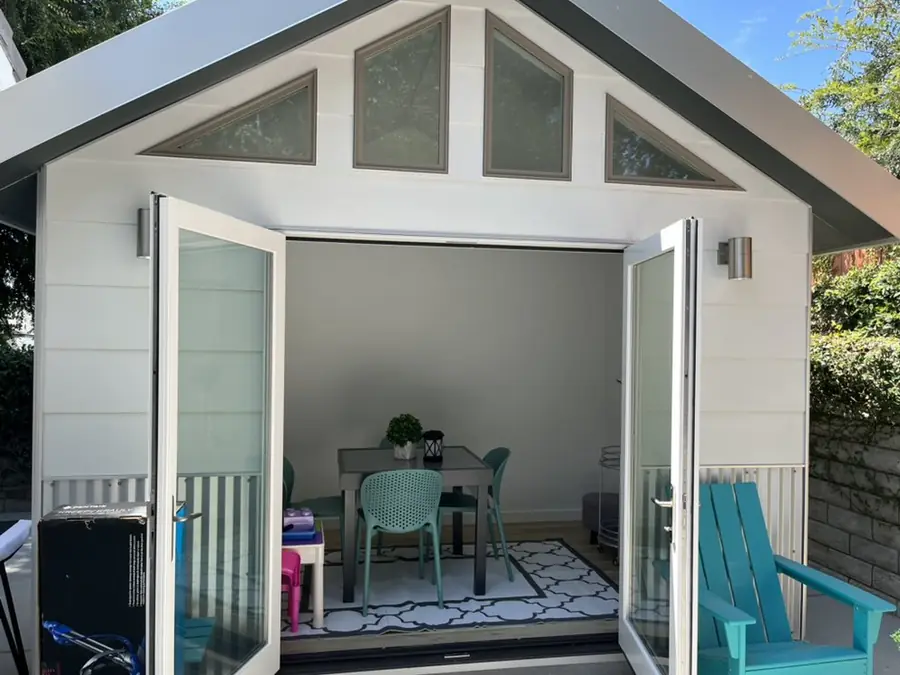 Backyard shed with double doors open after assembly