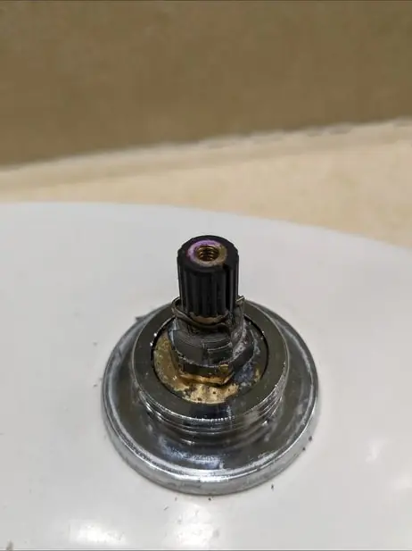 Shower valve cartridge pulled from the wall for replacement