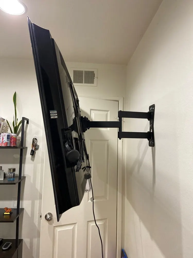 Flat-screen TV on an articulating wall mount pulled out from the wall