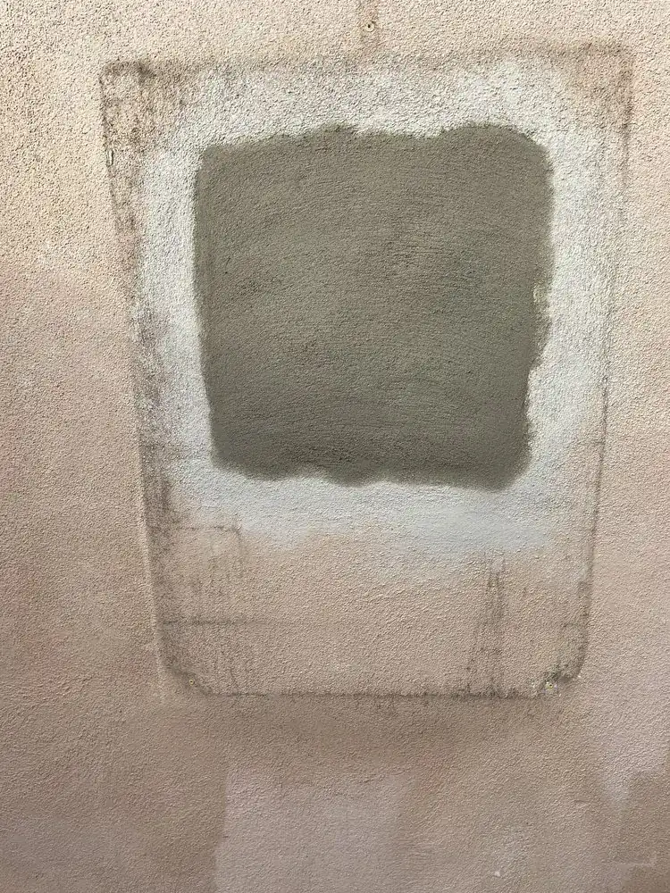 Drywall patch set into a wall, ready for compound and texture