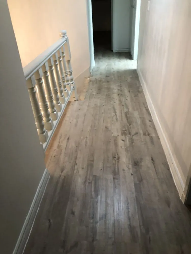 Upstairs hallway with new gray wood-look vinyl plank flooring